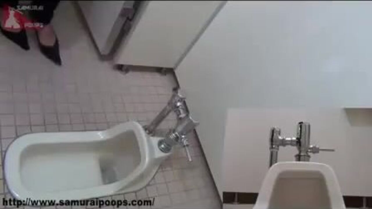 Watch this Japanese babe get her red hair drenched in a toilet pooper