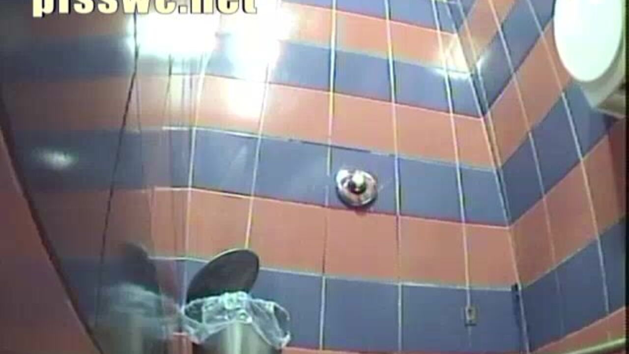 Beautiful girl goes crazy in a public toilet, taking a leak like a champ!