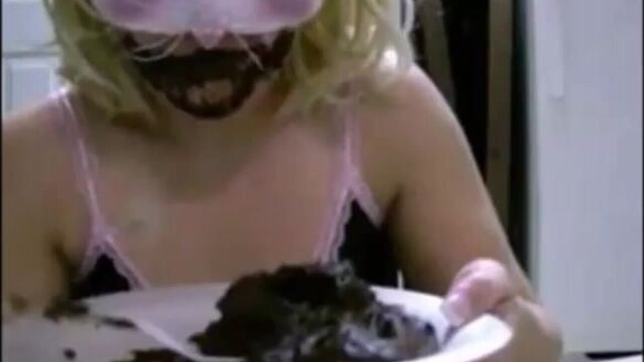 Blonde with mask slurps on her own scat and cums hard