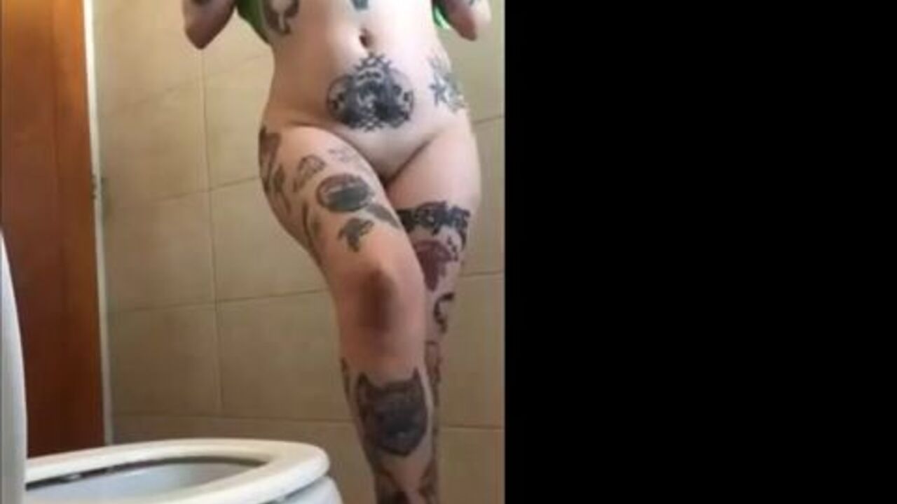 Watch this tattooed slut shitting in the bathroom like a pro