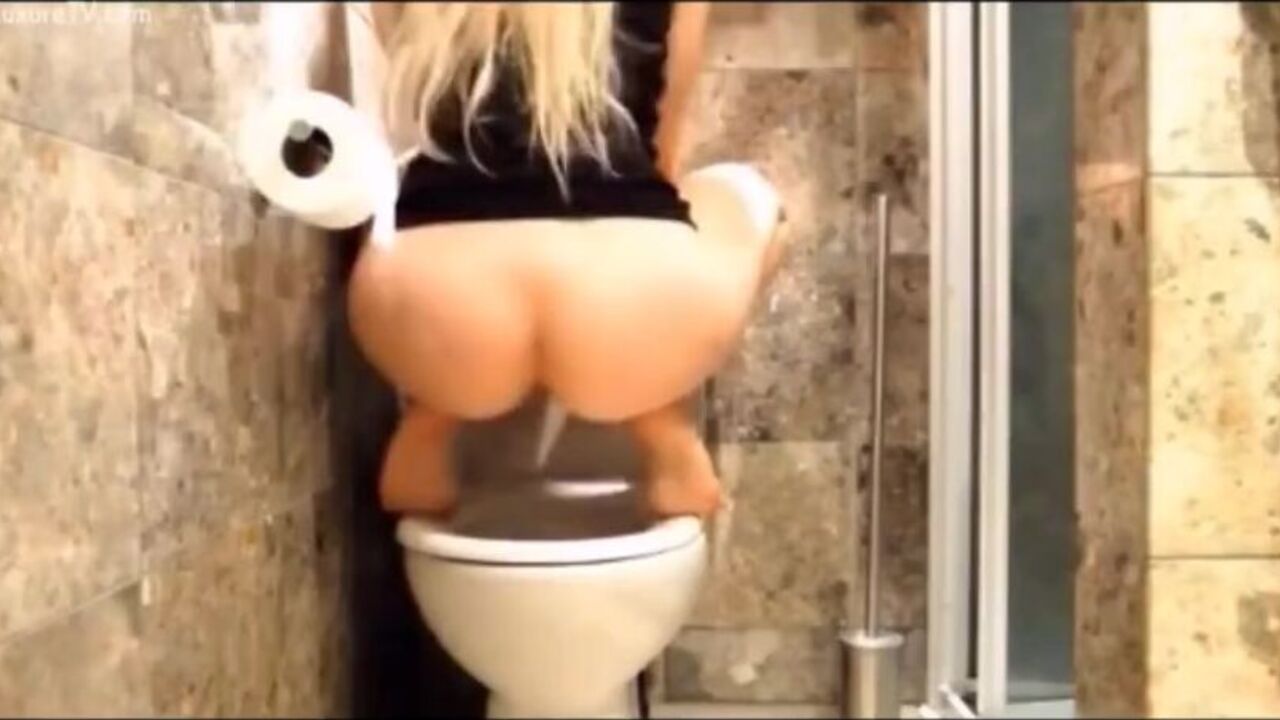 Blonde teen gets naughty in public toilet and swallows all her own jizz