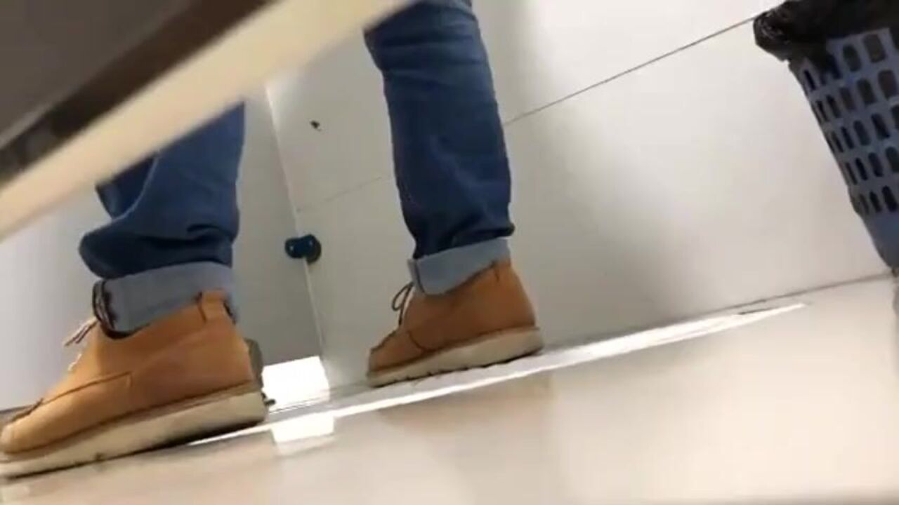 Watch as hot guys squat and piss in a public toilet