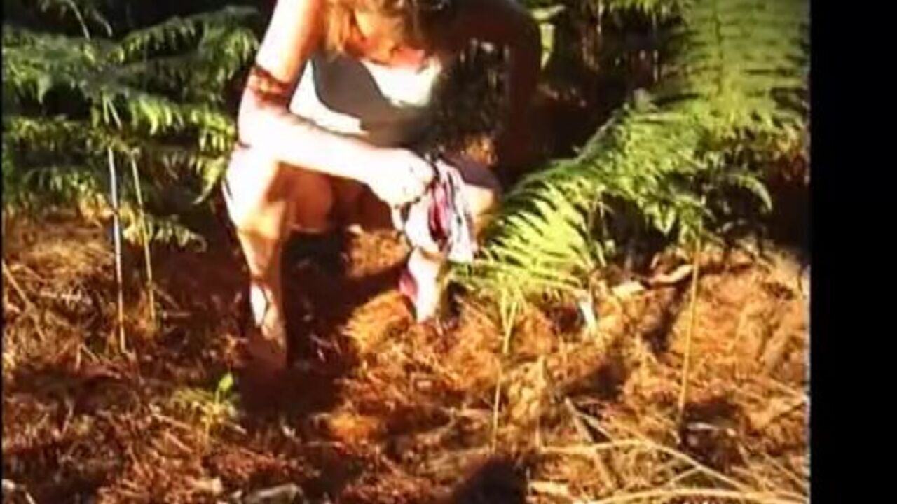 Watch her shitting in the woods like a dirty slut