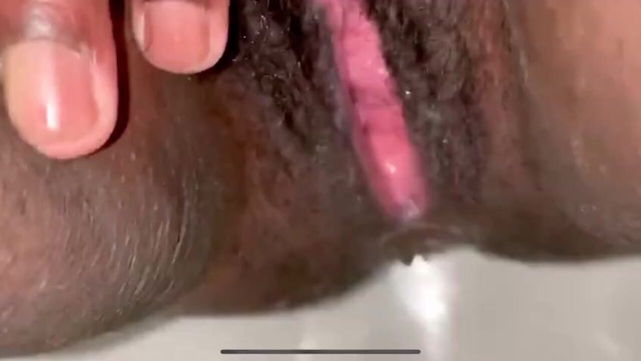 Watch this hot ebony babe get her sexy pussy drenched in her own piss