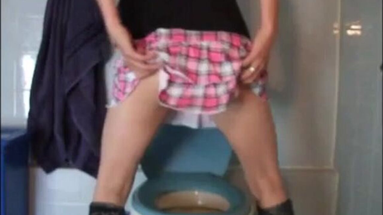 Watch this kinky girl in a miniskirt shitting in the toilet while her slave is away