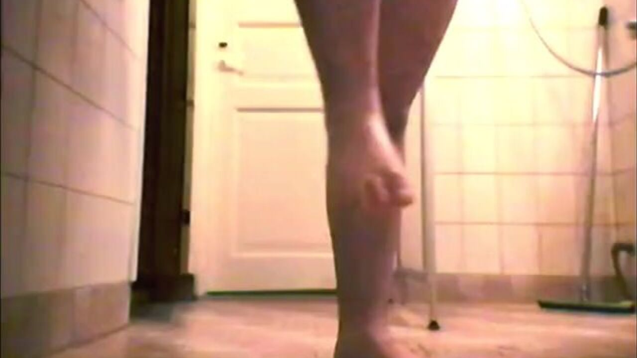 Naked guy smashes his own feet while pissing in public