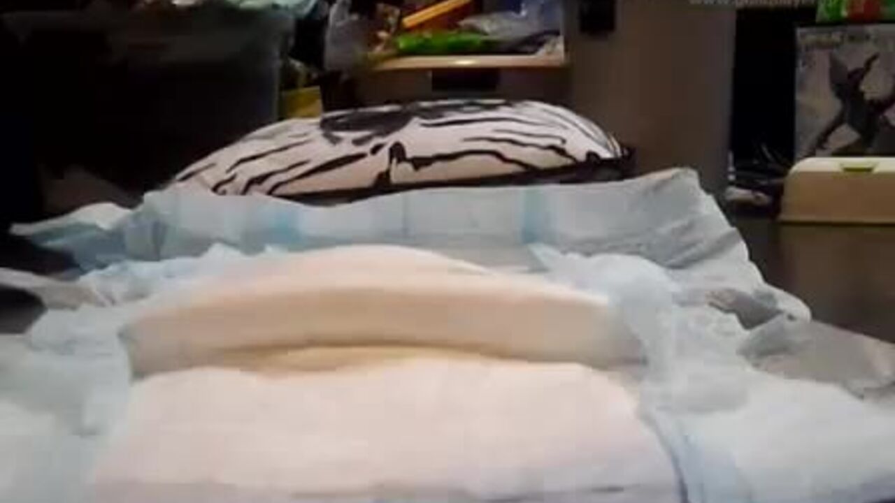 Watch this diaper-clad slut get a messy enema from her horny lover